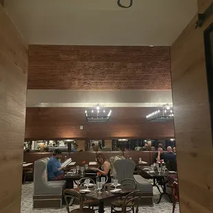 people sitting at tables in a restaurant