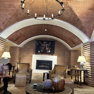 a living room with a fireplace and a chandelier