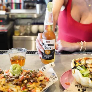 Ice cold beer + a Dos Amigos private label tequila with our Carne Asada Fries + Shrimp Tostada.