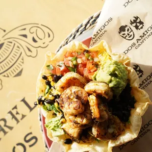 Shrimp Tostada Chopped romaine, seasoned black beans, pico de gallo,
guacamole, cilantro, corn, shredded
cheese &amp; your choice of meat.