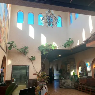 a man standing in a room with a chandelier