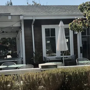 a patio with tables and chairs