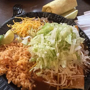 Enchilada with red sauce plate rice and beans