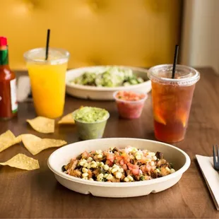 a bowl of salsa and chips on a table