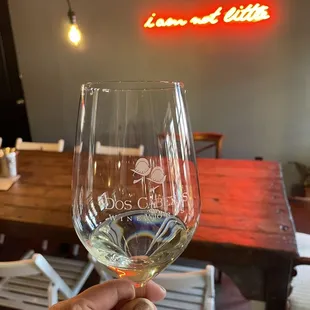 a hand holding a wine glass