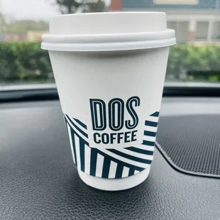 a coffee cup on the dashboard of a car