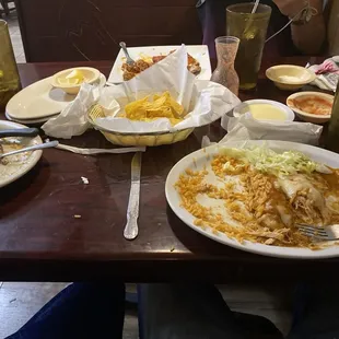 Chicken enchiladas, chips, 2 waters, steak burrito, sweet tea, queso sauce, and salsa and shrimp