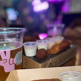 a glass of beer and a box of chicken nuggies