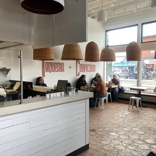 people sitting at tables in a restaurant