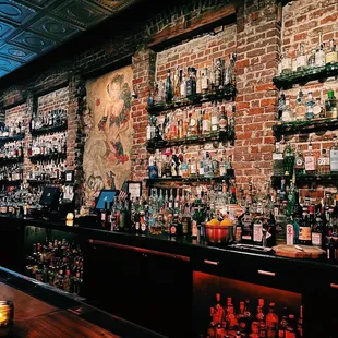 a brick wall with a lot of bottles on it