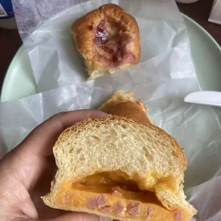 Cross section of a ham and cheddar, with a cherry/cheese in the background. About $7 incl a bottle of milk. JUL23