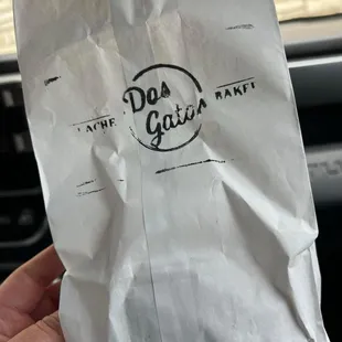 a person holding a bag of food