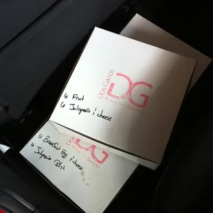 The Dos Gatos Special: 1.5 Lancer floorboards worth of kolaches, expertly boxed and labelled for office consumption.