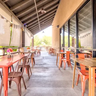 a patio with tables and chairs