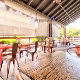 a patio with tables and chairs