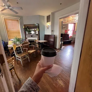 a person holding a coffee cup