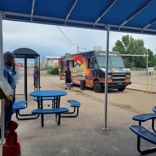 a man standing in front of a food truck