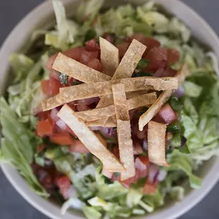 a bowl of salad with tortilla chips