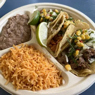 Asada, chicken, and al pastor taco plate with rice &amp; beans
