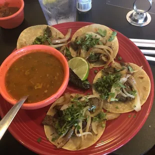 a plate of tacos and salsa