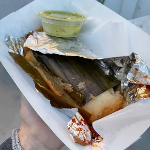 a hot dog wrapped in foil