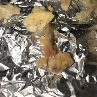 chicken and potatoes wrapped in aluminum foil