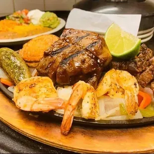 From their Facebook: Fajitas Parillada. Shrimp, ribs, beef and chicken fajita with grilled potatoes and a Chile toreado