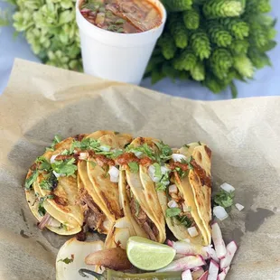 a plate of tacos and a bowl of salsa