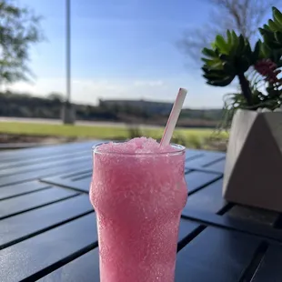 a pink drink on a table