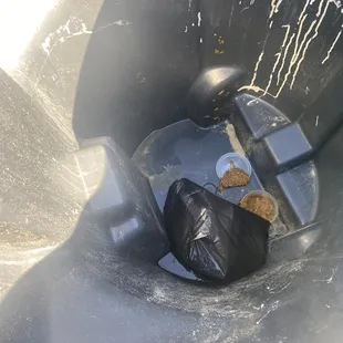 a black trash can with food in it