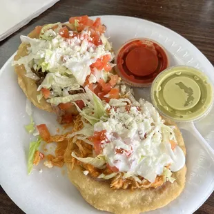 Chicken and fajita sopes with the spicy green salsa and salsa roja