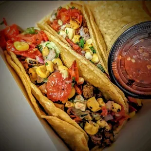 two tacos and a side of salsa