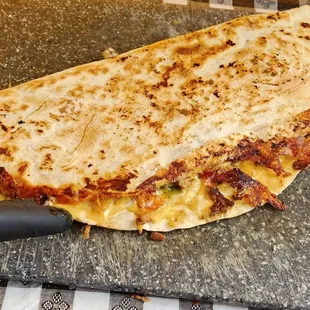 a quesadilla on a cutting board