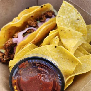 two tacos and a side of salsa