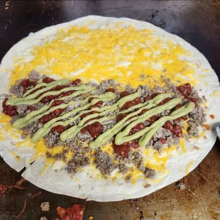 a burrito with cheese and guacamole