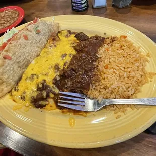 Cheese enchiladas, tamale, taco, rice, and beans.
