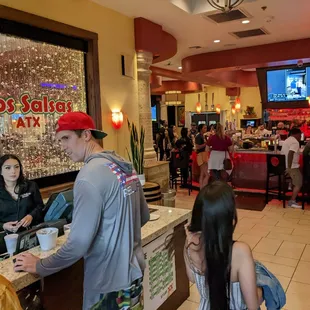 a man serving customers at a restaurant