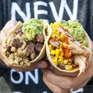 a person holding a burrito