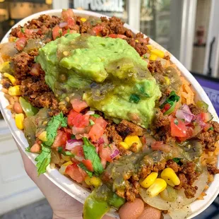 a hand holding a taco