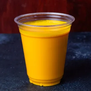 a plastic cup of orange juice