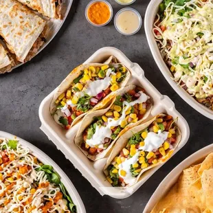 Taco dreams and quesadilla cravings come true! Fresh, vibrant Mexican flavors topped with creamy guac and spicy sides. Dig in!