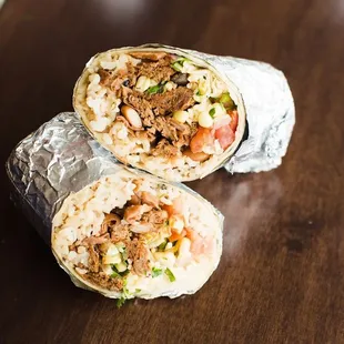a burrito cut in half on a table