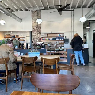 people sitting at tables in a coffee shop