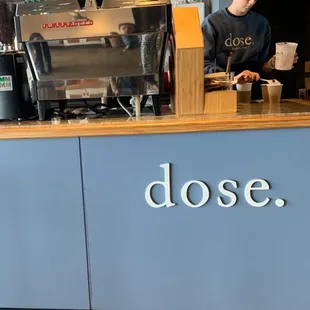 a man standing at a counter in a coffee shop