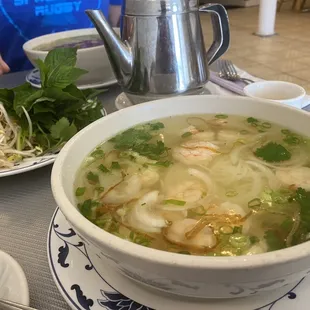 a bowl of soup and a plate of noodles