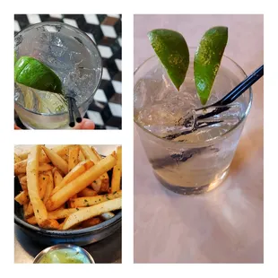 a glass of water with ice, a bowl of fries, and a lime wedge