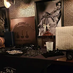 a table with a black table cloth and a picture of a woman