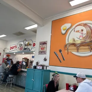 people sitting at a table in a diner