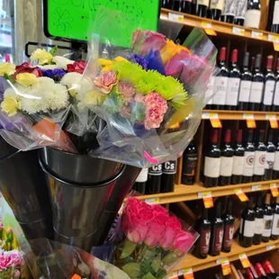 a bunch of flowers and bottles of wine