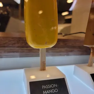 a yellow popsicle on a stick